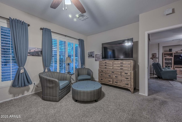 living area with carpet floors and ceiling fan