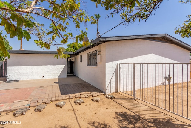 view of side of home with a patio area