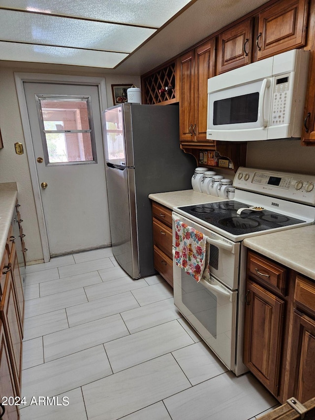 kitchen with a textured ceiling and white appliances