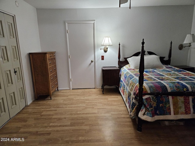 bedroom with wood-type flooring and a closet