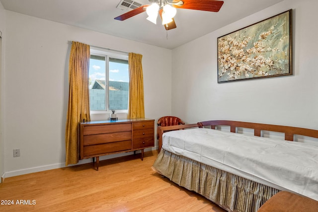 bedroom with light hardwood / wood-style floors and ceiling fan