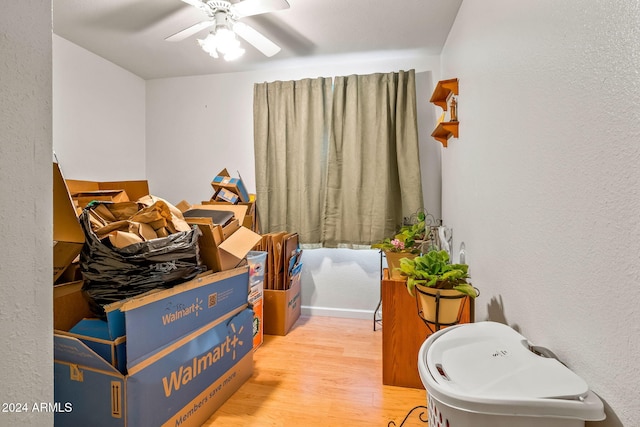 bathroom with hardwood / wood-style floors and ceiling fan