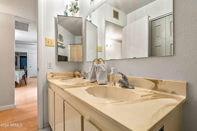 bathroom with hardwood / wood-style floors and vanity