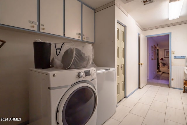 laundry area featuring cabinets and separate washer and dryer