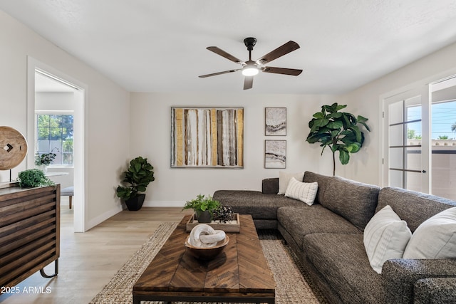 6001 N 10th Way, Phoenix, AZ 85014 - living room with healthy amount of natural light, light wood-type flooring, ceiling fan, and baseboards