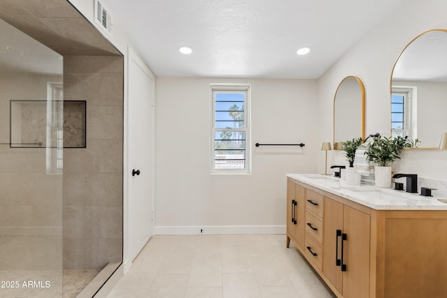 6001 N 10th Way, Phoenix, AZ 85014 - bathroom featuring double vanity, baseboards, a walk in shower, tile patterned flooring, and recessed lighting