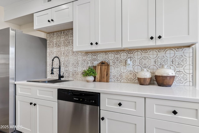 6001 N 10th Way, Phoenix, AZ 85014 - kitchen with stainless steel appliances, light countertops, white cabinetry, and tasteful backsplash