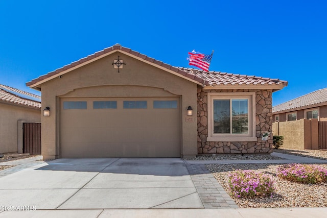 16573 W Alameda Rd, Surprise, AZ 85387 - view of front of property with fence, an attached garage, stucco siding, concrete driveway, and a tile roof
