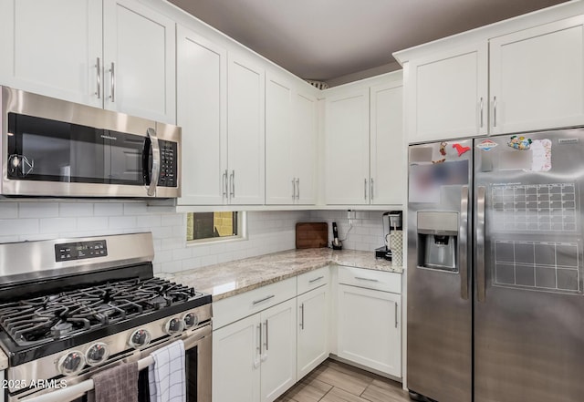 16573 W Alameda Rd, Surprise, AZ 85387 - kitchen featuring decorative backsplash, white cabinets, stainless steel appliances, and light stone countertops