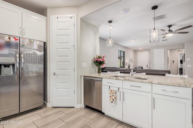 16573 W Alameda Rd, Surprise, AZ 85387 - kitchen featuring visible vents, a sink, appliances with stainless steel finishes, a peninsula, and white cabinets