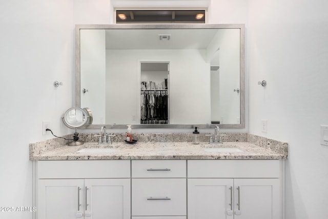 16573 W Alameda Rd, Surprise, AZ 85387 - full bath featuring double vanity, visible vents, a walk in closet, and a sink