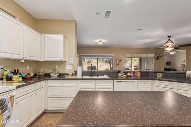 kitchen featuring white cabinets, dishwasher, ceiling fan, and sink