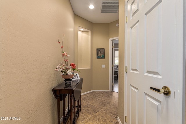 hallway with tile patterned floors