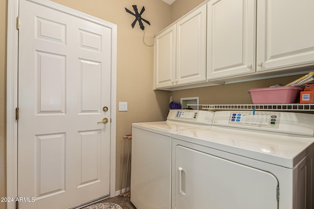 washroom featuring cabinets and independent washer and dryer