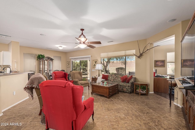 living room with ceiling fan and sink