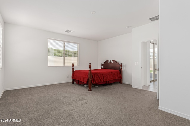 bedroom featuring light colored carpet