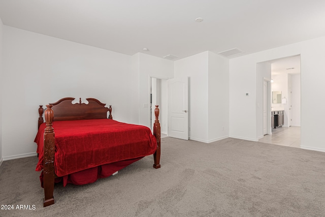 carpeted bedroom featuring ensuite bath