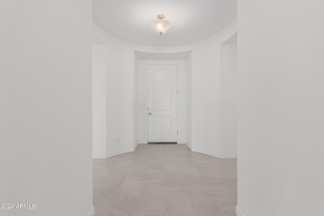 corridor with light tile patterned floors