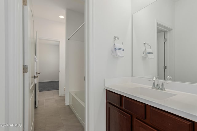 bathroom featuring tile patterned floors, shower / tub combination, and vanity