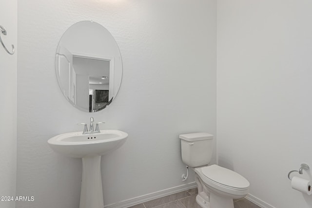 bathroom with sink, tile patterned floors, and toilet