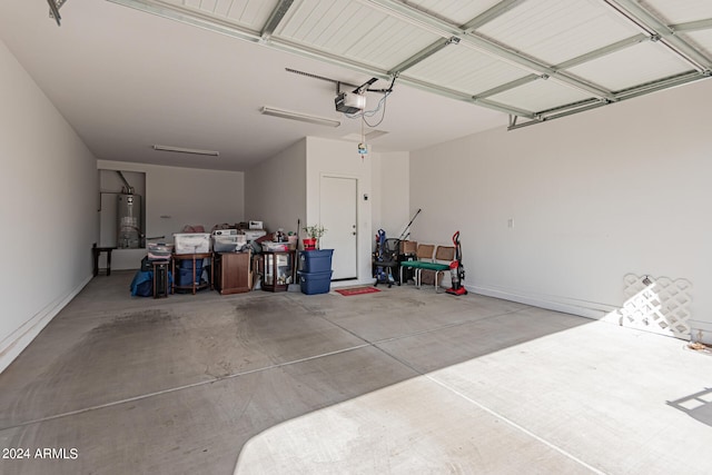 garage featuring gas water heater and a garage door opener