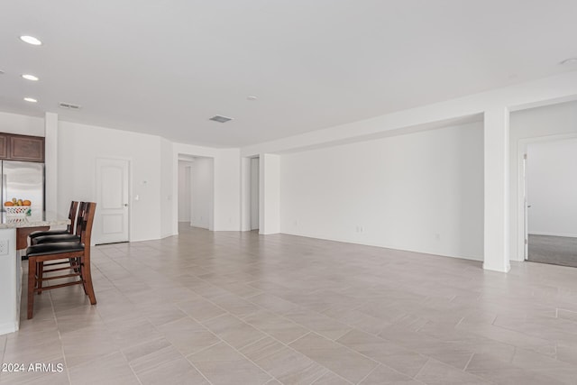 unfurnished living room with light tile patterned floors