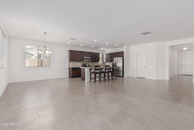 tiled living room featuring an inviting chandelier