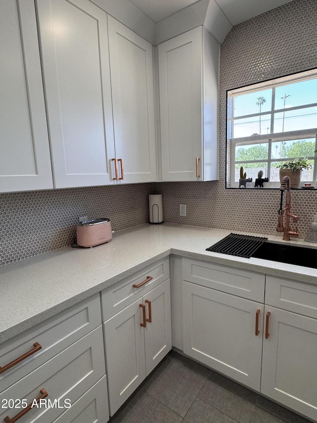 1222 E Almeria Rd, Phoenix, AZ 85006 - kitchen with a sink, light countertops, decorative backsplash, and white cabinetry