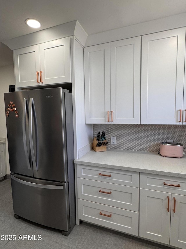 1222 E Almeria Rd, Phoenix, AZ 85006 - kitchen with freestanding refrigerator, white cabinets, tasteful backsplash, and recessed lighting