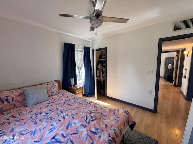 1222 E Almeria Rd, Phoenix, AZ 85006 - bedroom featuring light wood-style flooring, a closet, baseboards, and a ceiling fan