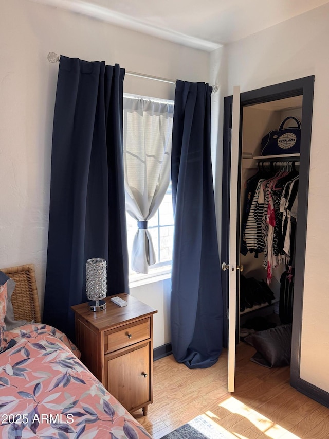 1222 E Almeria Rd, Phoenix, AZ 85006 - bedroom featuring a closet, light wood-type flooring, and a walk in closet