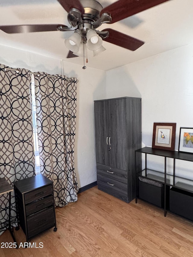 1222 E Almeria Rd, Phoenix, AZ 85006 - unfurnished bedroom with wood finished floors, baseboards, and ceiling fan