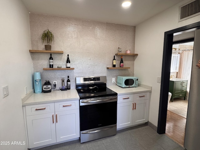1222 E Almeria Rd, Phoenix, AZ 85006 - kitchen with electric range, open shelves, backsplash, light countertops, and recessed lighting