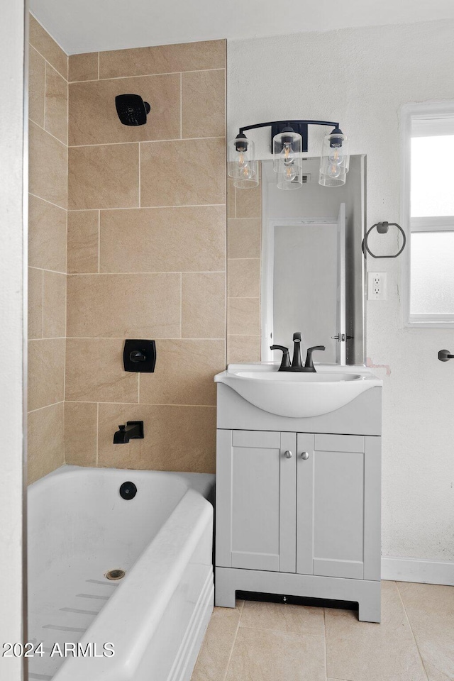 bathroom with tile patterned flooring, vanity, and tiled shower / bath combo