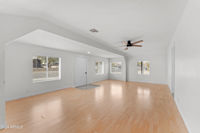 unfurnished living room with a wealth of natural light, ceiling fan, and light wood-type flooring