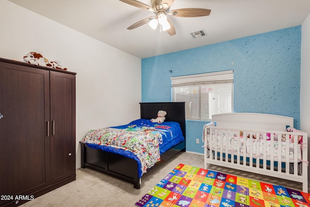 bedroom with light carpet and ceiling fan