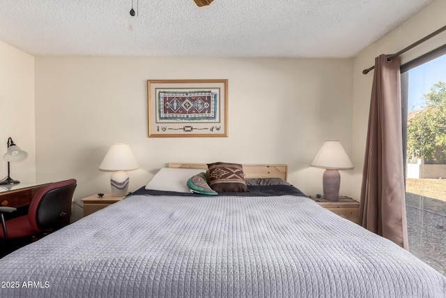 bedroom featuring a textured ceiling and access to outside