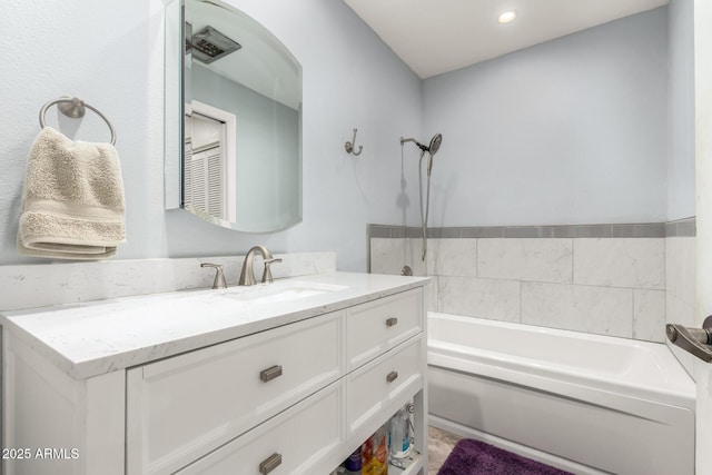 bathroom featuring vanity and a washtub