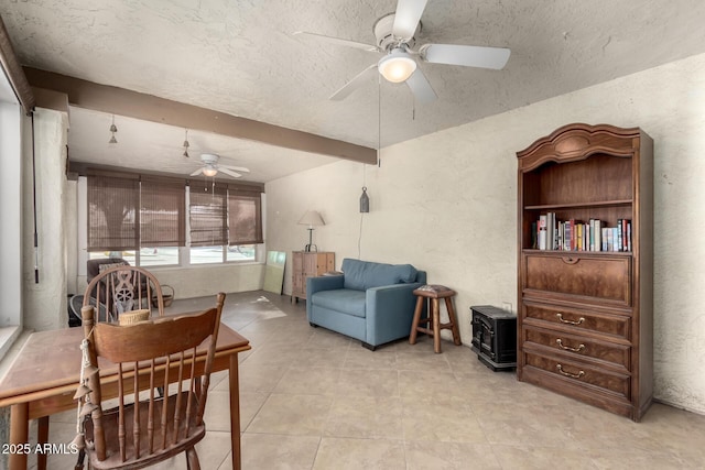 living area featuring a textured ceiling, ceiling fan, and light tile patterned floors