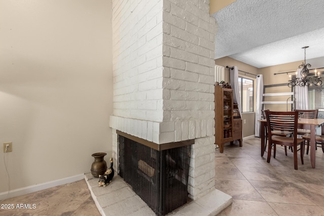 tiled living room with a multi sided fireplace, a textured ceiling, and a chandelier