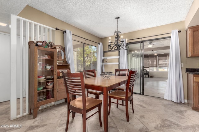 dining space with light tile patterned floors, a chandelier, and a textured ceiling