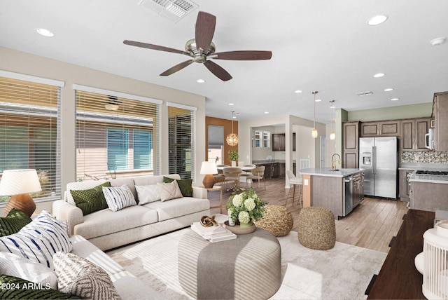 731 E Verde Blvd, Queen Creek, AZ 85140 - living room with ceiling fan, light wood-style floors, and recessed lighting