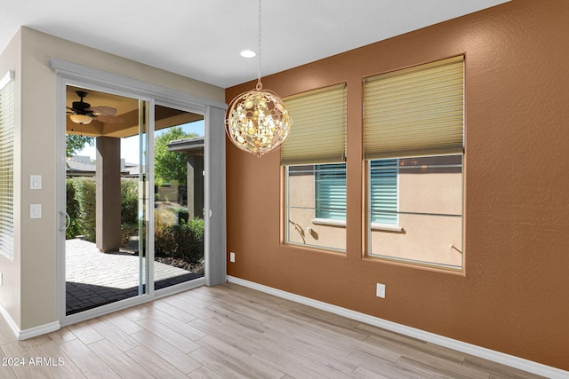 731 E Verde Blvd, Queen Creek, AZ 85140 - unfurnished dining area featuring wood finished floors, a chandelier, baseboards, a ceiling fan, and a textured wall