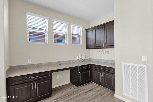 731 E Verde Blvd, Queen Creek, AZ 85140 - kitchen featuring light wood-type flooring, light countertops, baseboards, and dark brown cabinets