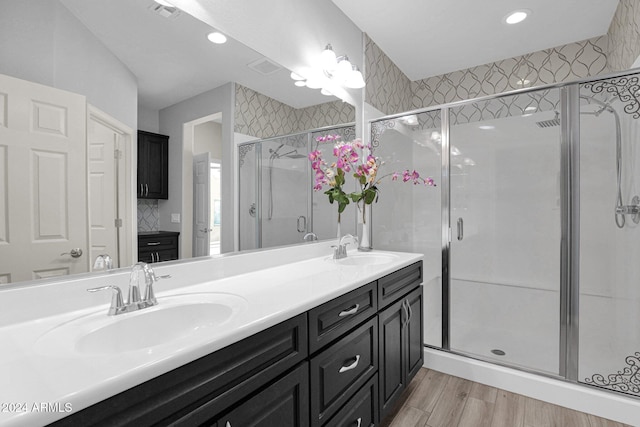 731 E Verde Blvd, Queen Creek, AZ 85140 - full bathroom with double vanity, a stall shower, wood finished floors, and recessed lighting