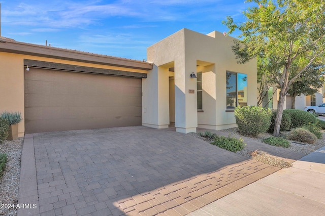 731 E Verde Blvd, Queen Creek, AZ 85140 - view of front facade with stucco siding, decorative driveway, and an attached garage