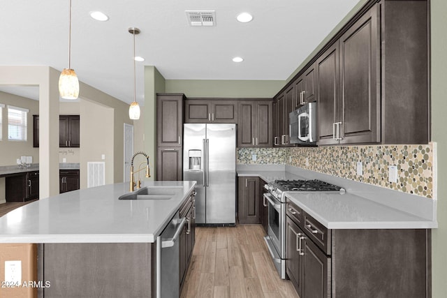 731 E Verde Blvd, Queen Creek, AZ 85140 - kitchen featuring stainless steel appliances, a sink, dark brown cabinets, light countertops, and recessed lighting