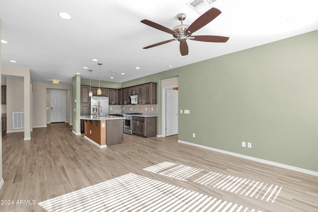 731 E Verde Blvd, Queen Creek, AZ 85140 - kitchen with open floor plan, stainless steel appliances, baseboards, light wood-type flooring, and recessed lighting