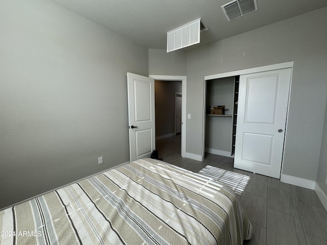 bedroom featuring dark hardwood / wood-style flooring and a closet