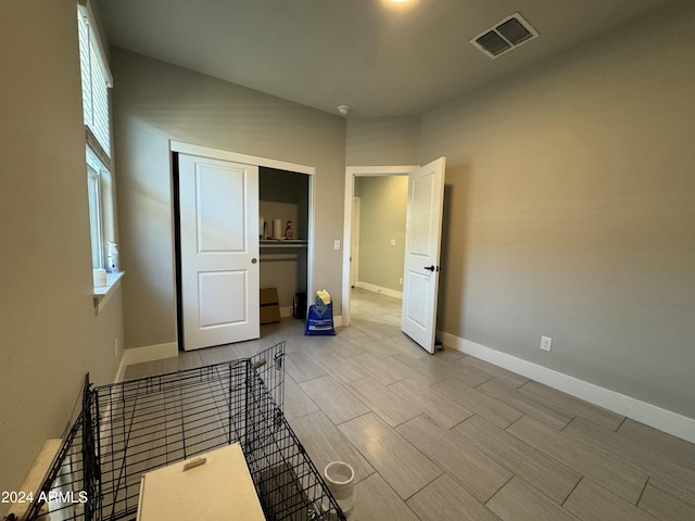 unfurnished bedroom featuring light hardwood / wood-style flooring and a closet